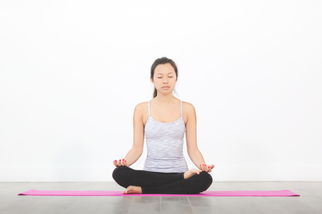 A woman meditating in the lotus position