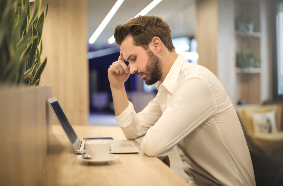 A man focusing intensely at his laptop